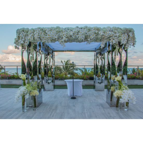 Pair of tall geometric columns in white and black with mirrored interior panels, modern event pedestals for décor and displays.