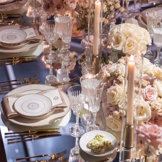 White dessert plate with thin gold rim and small gold circular detailing in the center, small round plate on a white background