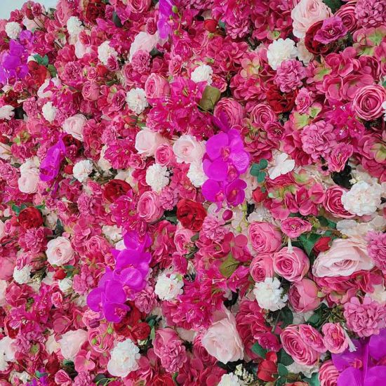 Bright fuchsia flower wall backdrop with dense mixed blooms, bold romantic photo backdrop panel for weddings and event décor styling.
