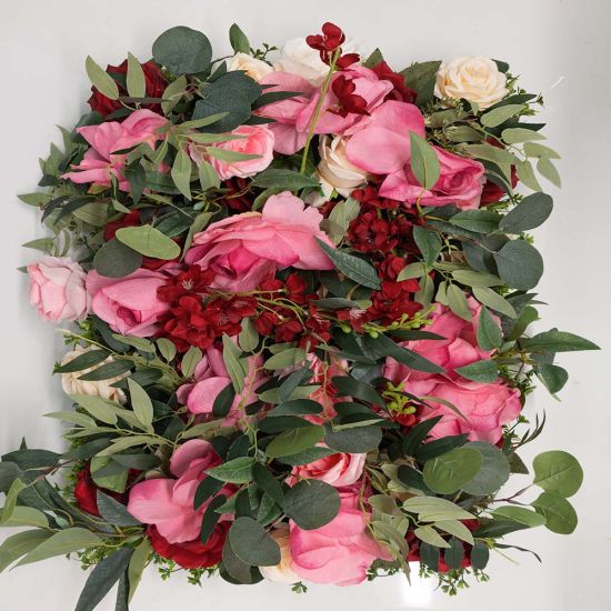 Green hedge wall with floral border frame of pink and white blooms, garden-style backdrop panel for weddings and photo booth setups.