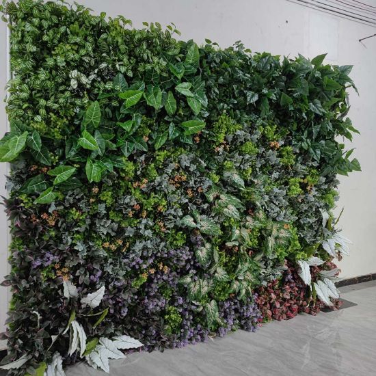 Lush green foliage wall backdrop with mixed leaves and floral accents, garden-style photo backdrop panel for weddings and events.