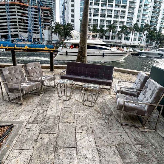 Black velvet lounge armchair with polished silver frame and open square base, modern luxury seating for upscale event lounges.
