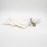 Diamond rope napkin holder with twisted rope-style band and sparkling diamond accents securing a folded white cloth napkin for elegant tables