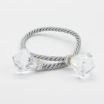 Diamond rope napkin holder with twisted rope-style band and sparkling diamond accents securing a folded white cloth napkin for elegant tables