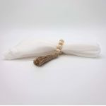 Boho chic wood bead napkin ring with natural wooden beads and rustic texture securing a folded white cloth napkin for event table settings