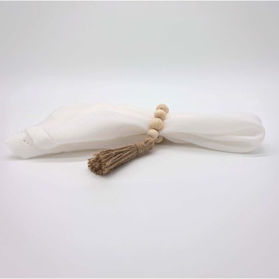 Boho chic wood bead napkin ring with natural wooden beads and rustic texture securing a folded white cloth napkin for event table settings