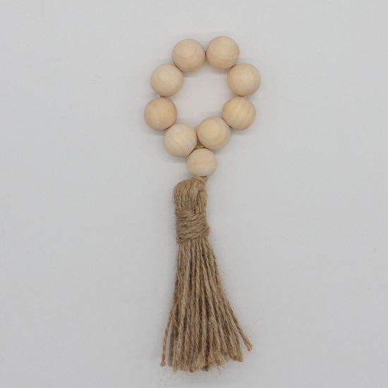 Boho chic wood bead napkin ring with natural wooden beads and rustic texture securing a folded white cloth napkin for event table settings
