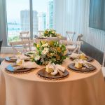 Boho chic wood bead napkin ring with natural wooden beads and rustic texture securing a folded white cloth napkin for event table settings