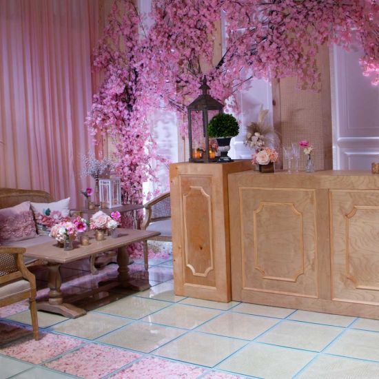 Natural wood colonial-style pedestal column with paneled cabinet-like design, rustic event decor display stand for weddings and props.