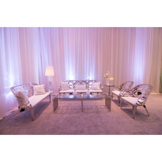 Silver reflective Butterfly Reflection armchair with circular cutout backrest and white cushioned seat, modern event lounge chair rental