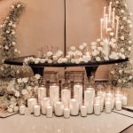 Reflection Serpentine gold table with stainless steel top, curved serpentine dining table with gold legs for luxury event rentals and décor.