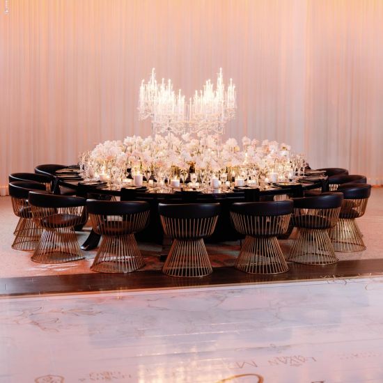 Reflection Serpentine gold table with stainless steel top, curved serpentine dining table with gold legs for luxury event rentals and décor.