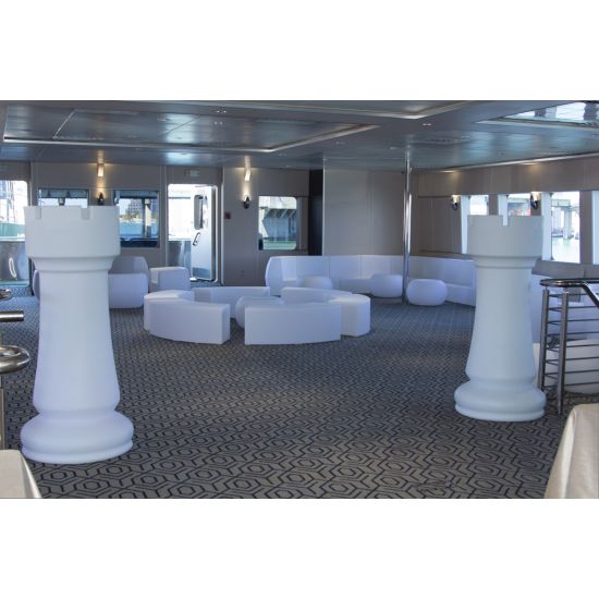 Oversized white chess rook pedestal prop with black top, modern statement décor piece.