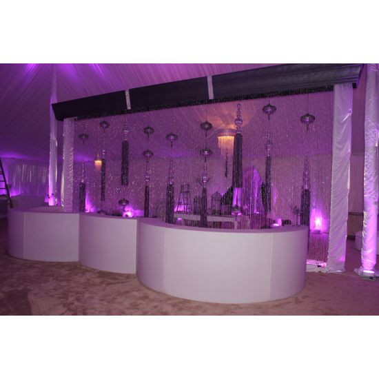Serpentine white LED-lit South Beach Glow bar rental unit with wave-shape front for modern luxury event cocktail stations