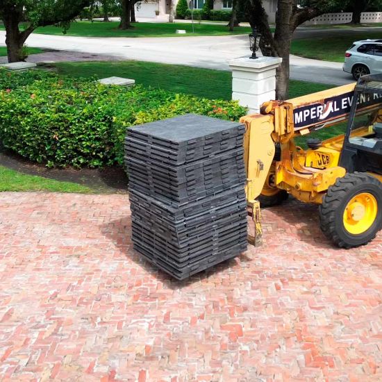 Black Duratrack subfloor under tent with 32x32 size overlay text, modular 4x4 panels used as heavy-duty outdoor event floor base.