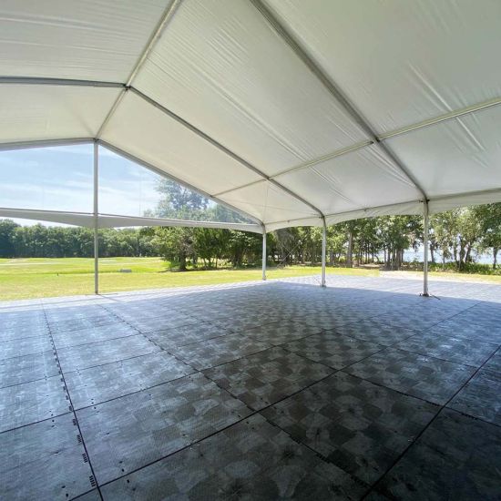 Black Duratrack subfloor under tent with 32x32 size overlay text, modular 4x4 panels used as heavy-duty outdoor event floor base.