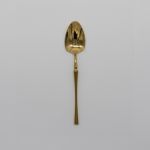 Shiny gold dinner spoon with classic slim handle, chic disposable flatware set of 10 for catered events, weddings, and elegant table décor.