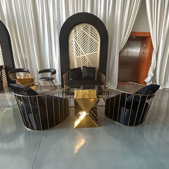 Yellow velvet accent loveseat with gold metal bar frame and two black pillows, modern art deco lounge seating for luxury events.